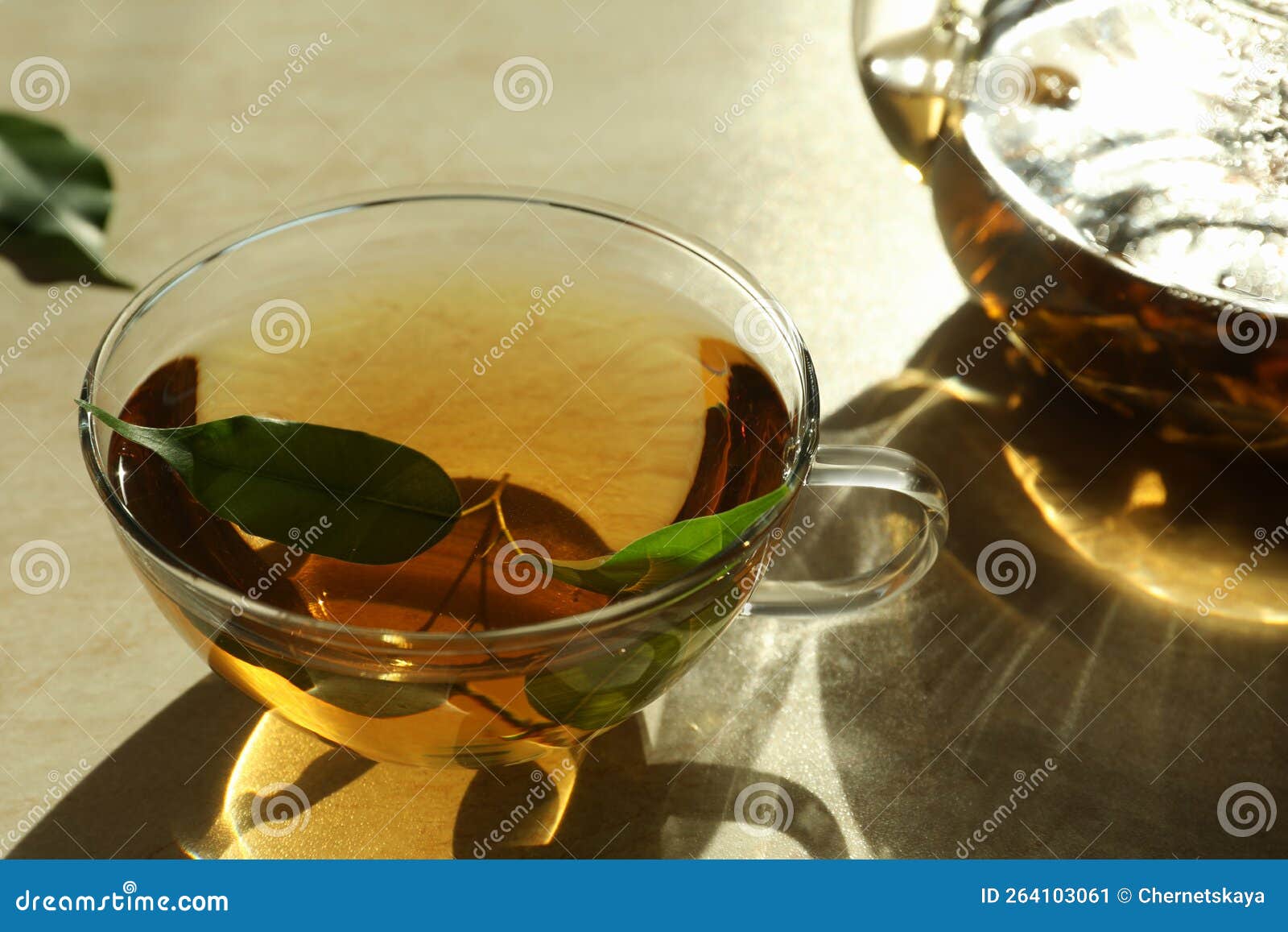 Fresh Green Tea in Glass Cup with Leaves on Table, Closeup Stock Image