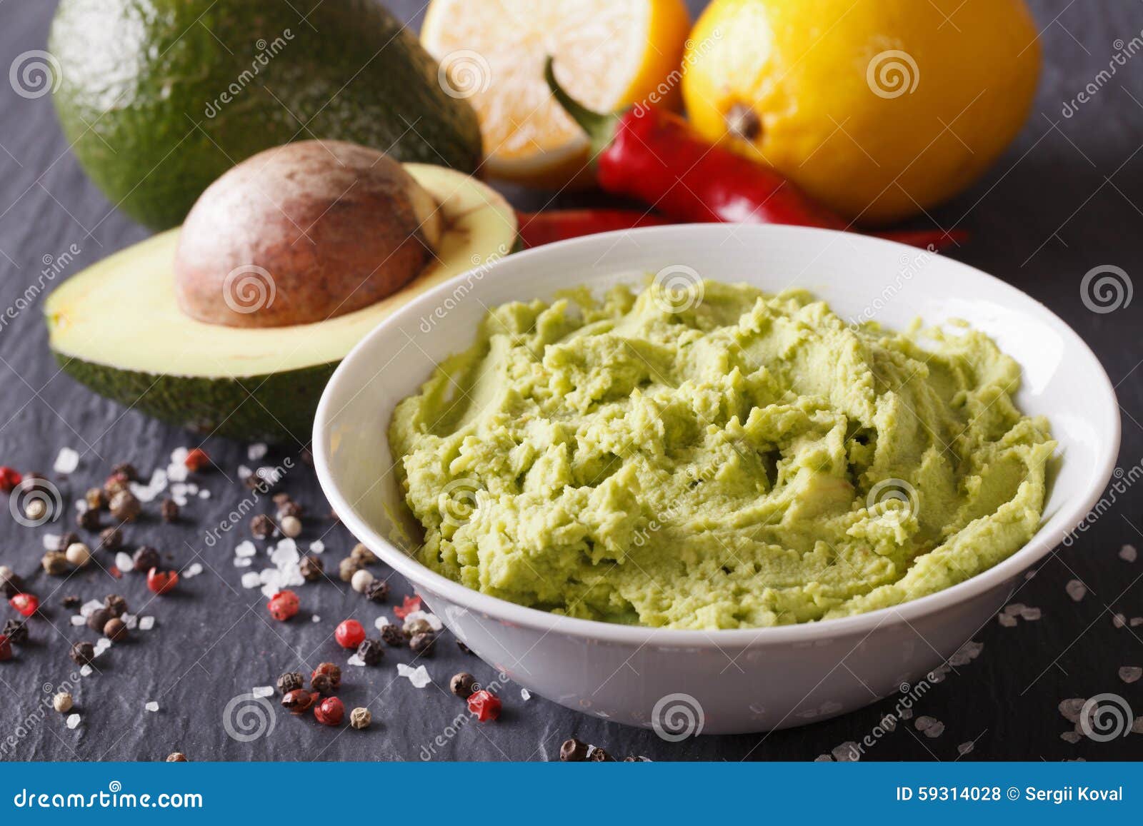Fresh Guacamole Sauce with Ingredients Closeup. Horizontal Stock Photo