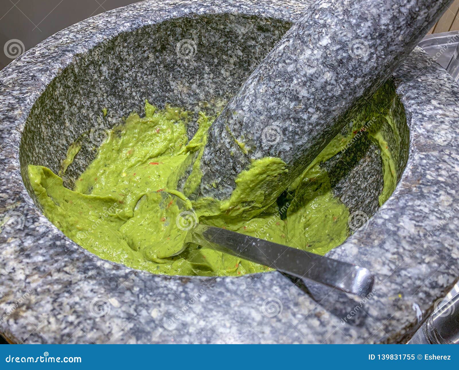 fresh guacomole in a stone mortar