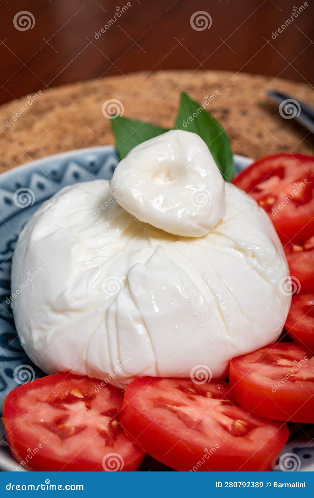 fresh handmade soft italian cheese from puglia, white ball of burrata foglia saporosa or burratina cheese made from mozzarella and