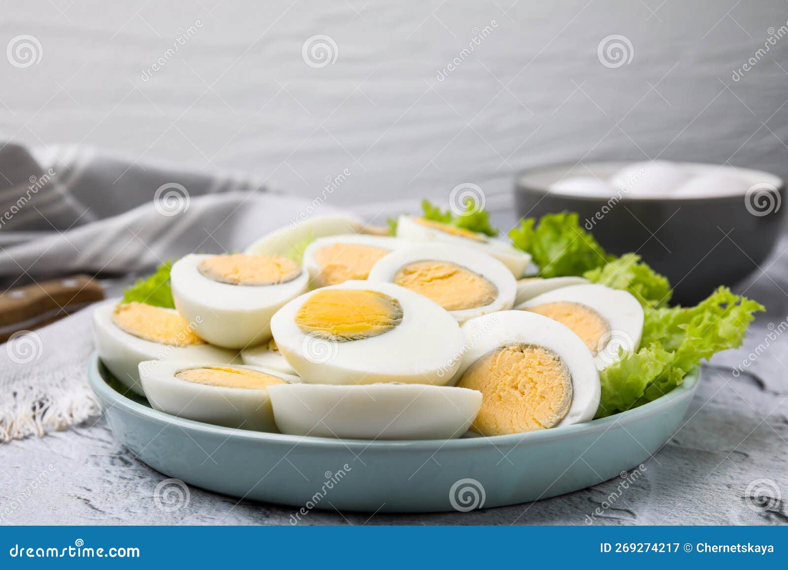 Fresh Hard Boiled Eggs and Lettuce on Light Grey Textured Table Stock
