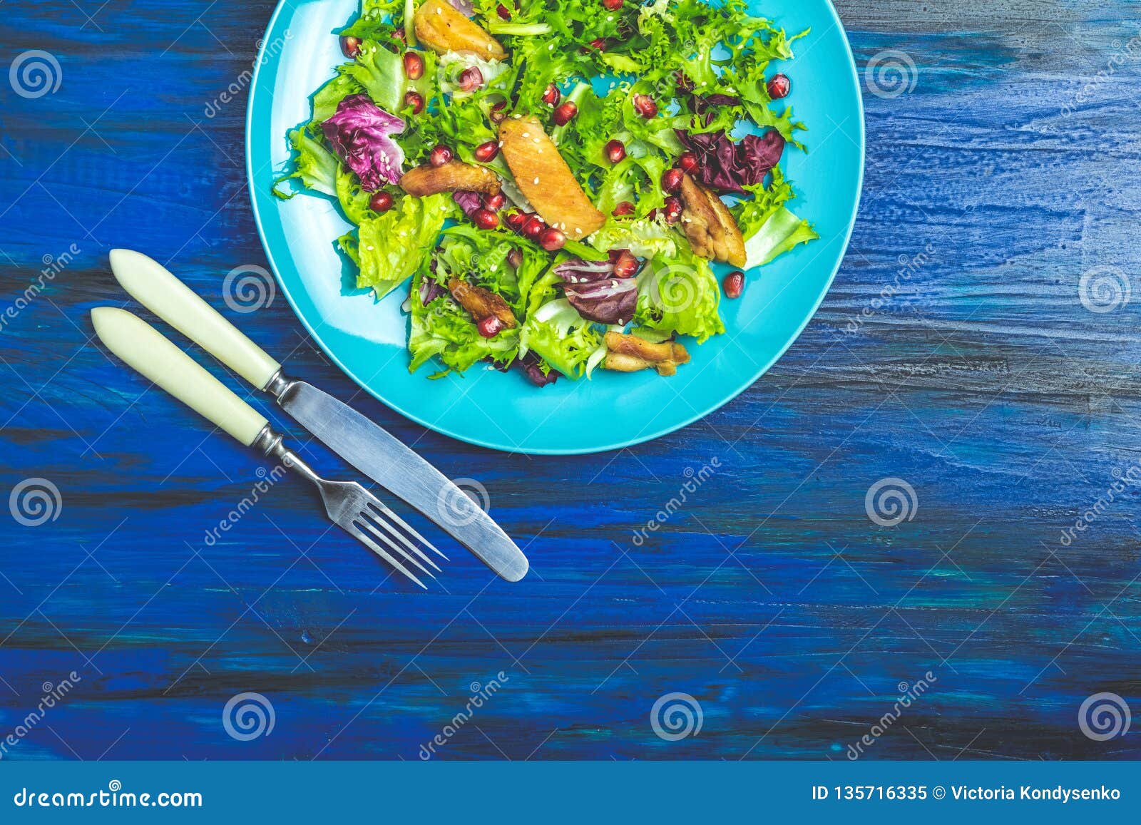 Fresh Healthy Salad With Lettuce Chicken And Pomegranate In Blue Plate