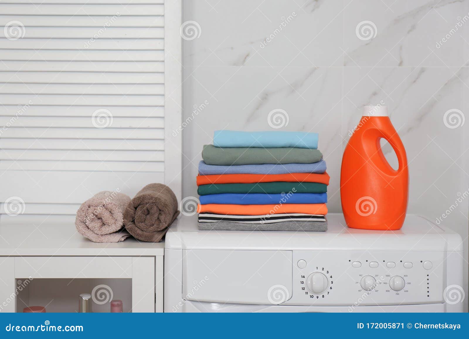 Fresh Laundry and Detergent on Washing Machine in Room Stock Image