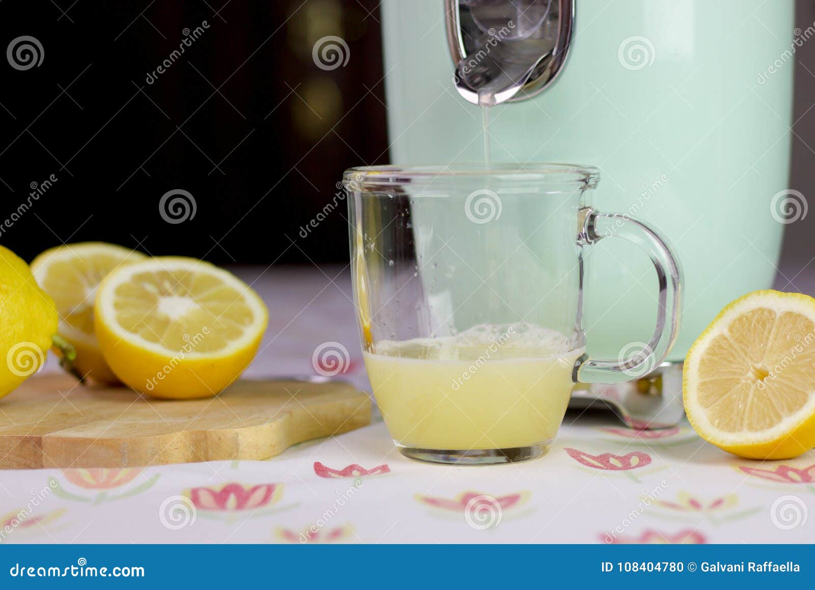 Fresh Lemon Juice Comes Out from the Citrus Squeezer Stock Photo