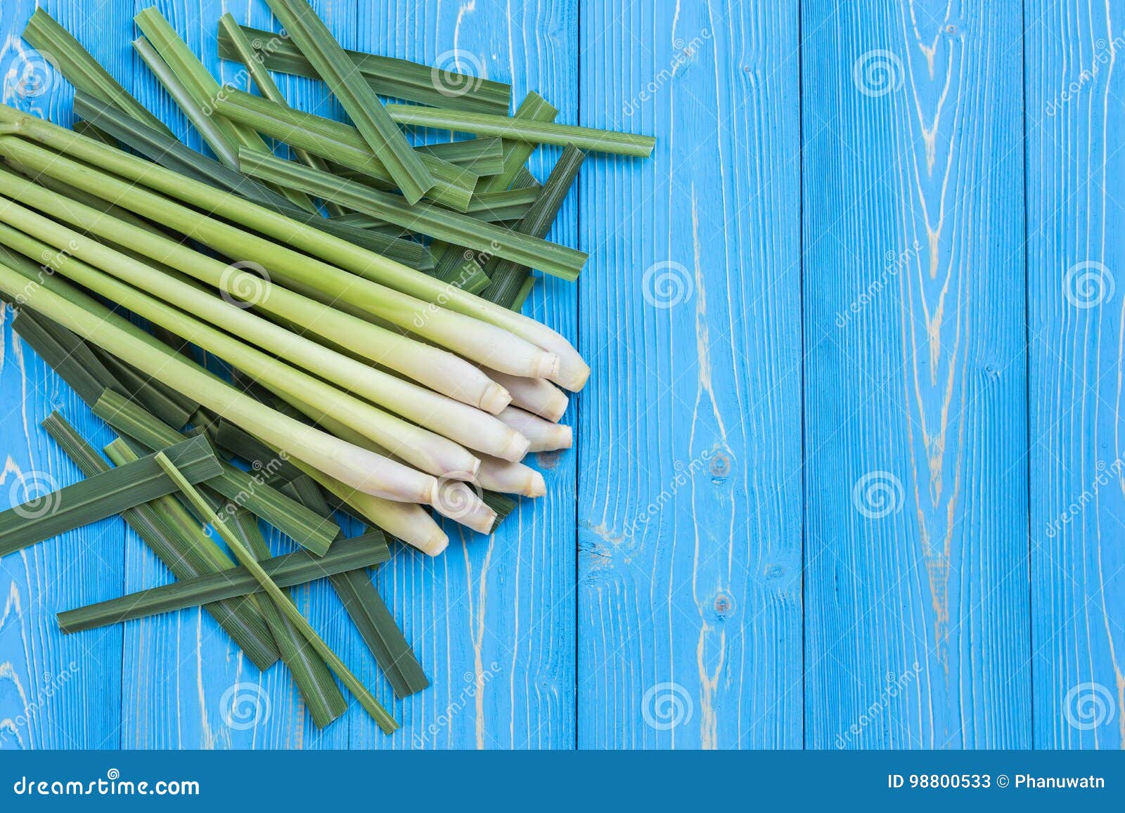 fresh lemongrass or citronella grass leaf on blue wooden plank