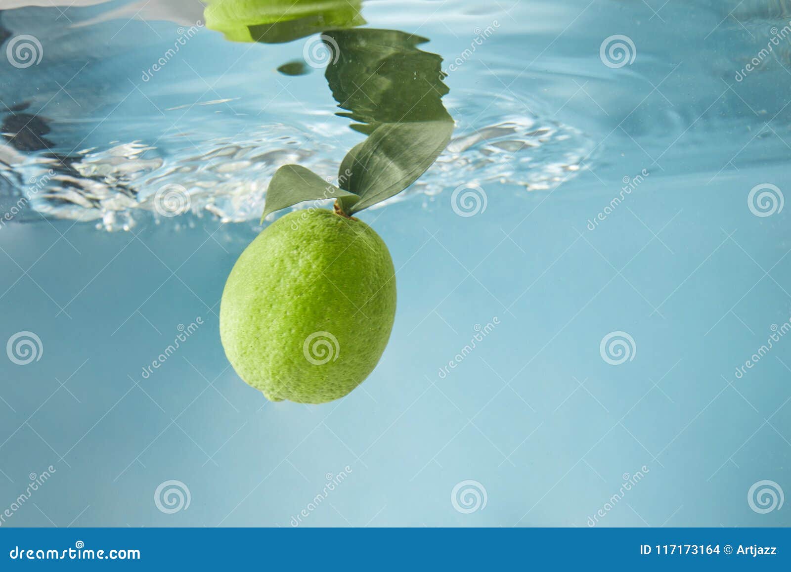 Fresh Lime in Water Isolated on a Blue Background Stock Photo - Image ...