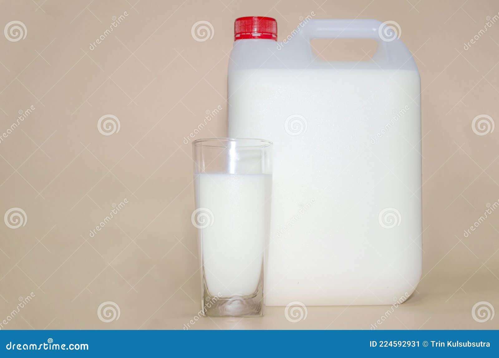 Fresh Milk is Packed in a White Plastic Container on an Orange Tone