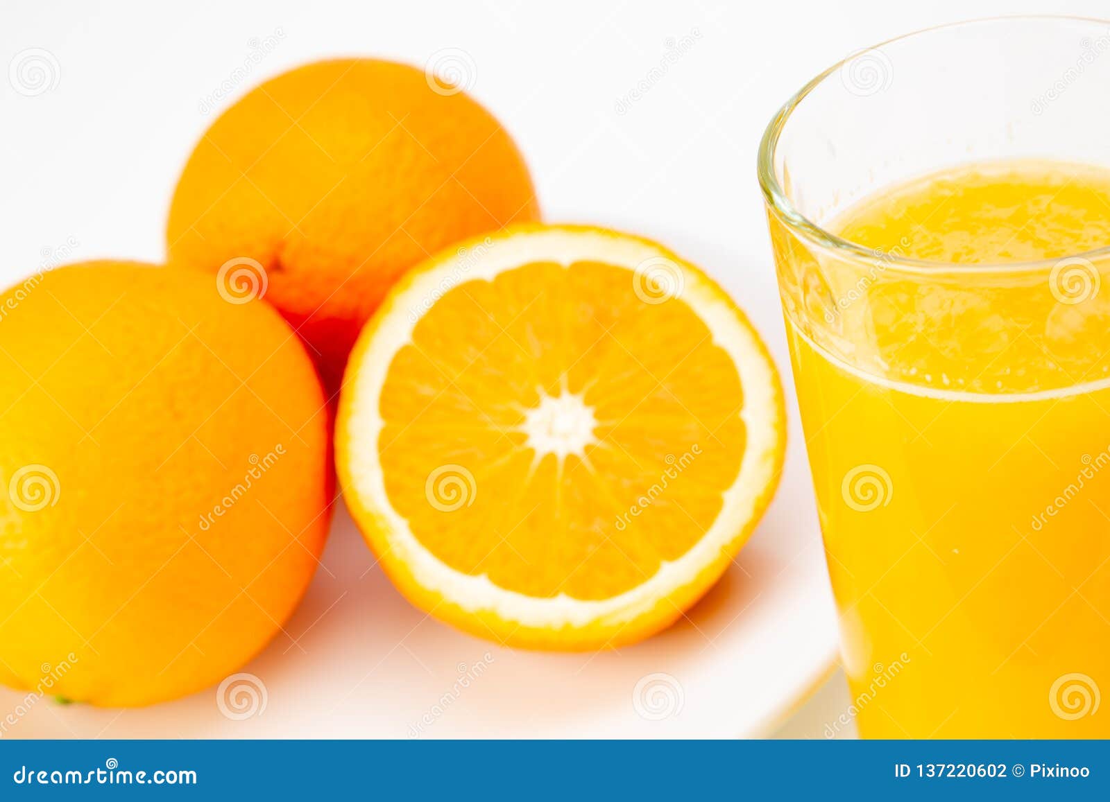 Fresh Orange Juice and Half Orange on White Background Stock Photo