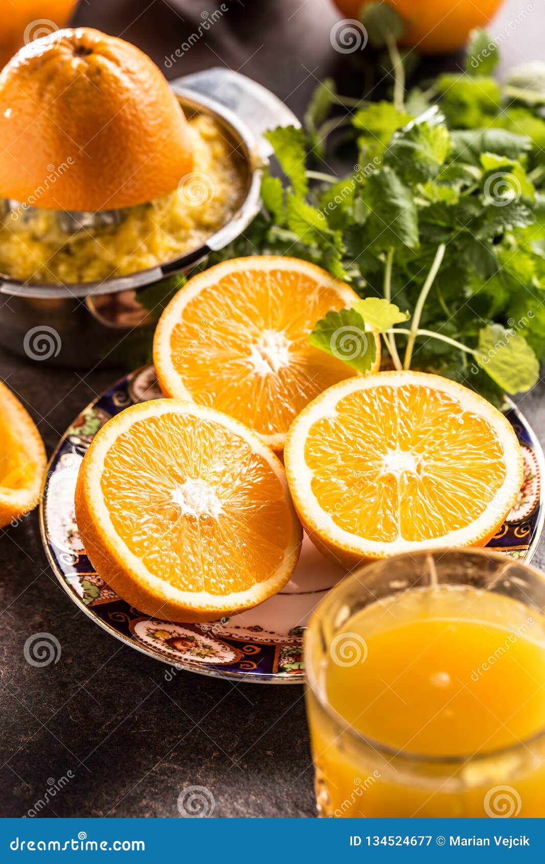 Fresh Oranges Juicer Juice Tropical Fruits And Herbs On Concrete Board