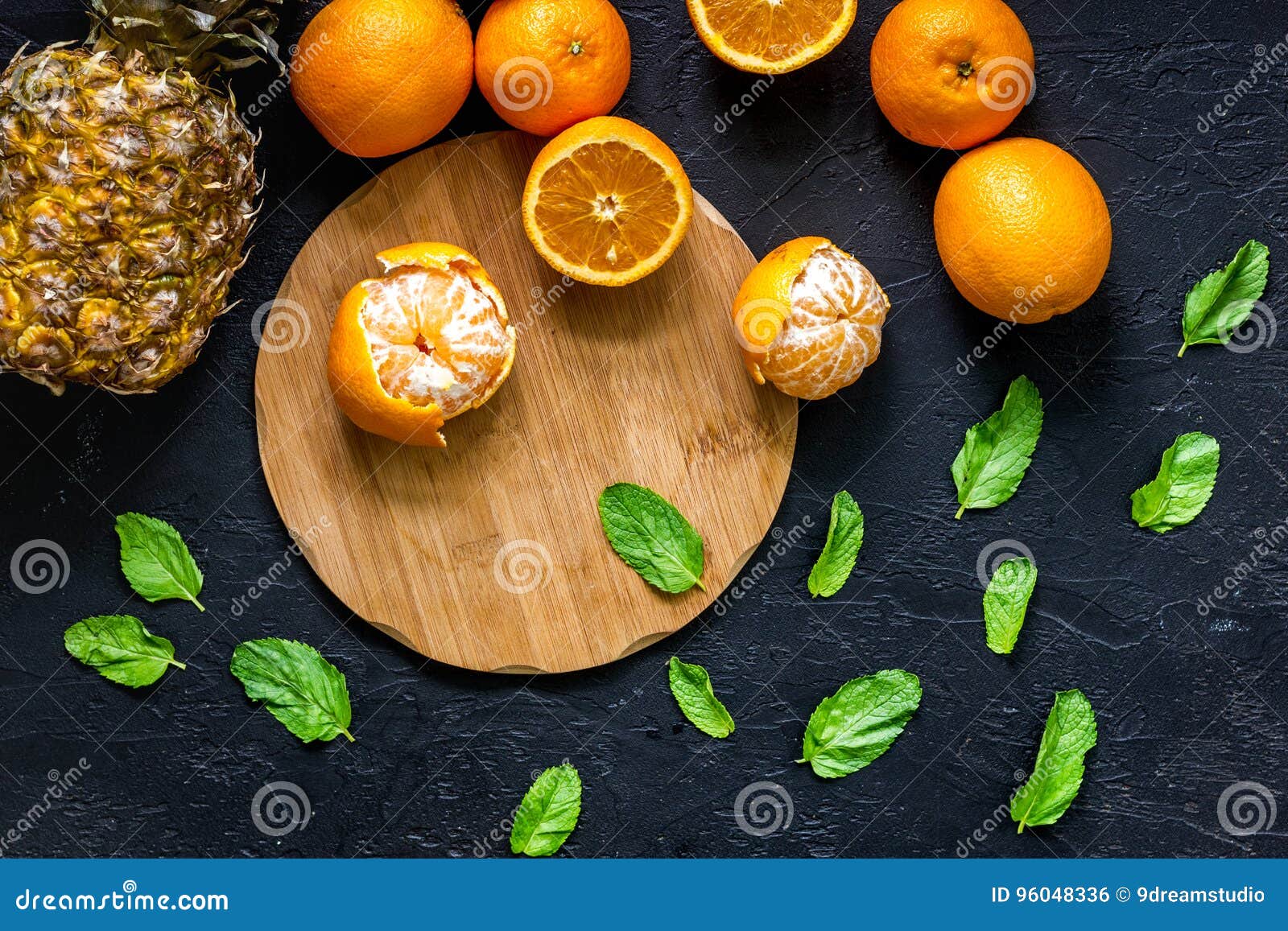 Fresh Oranges, Mandarins and Pineapple on Black Table Background Top