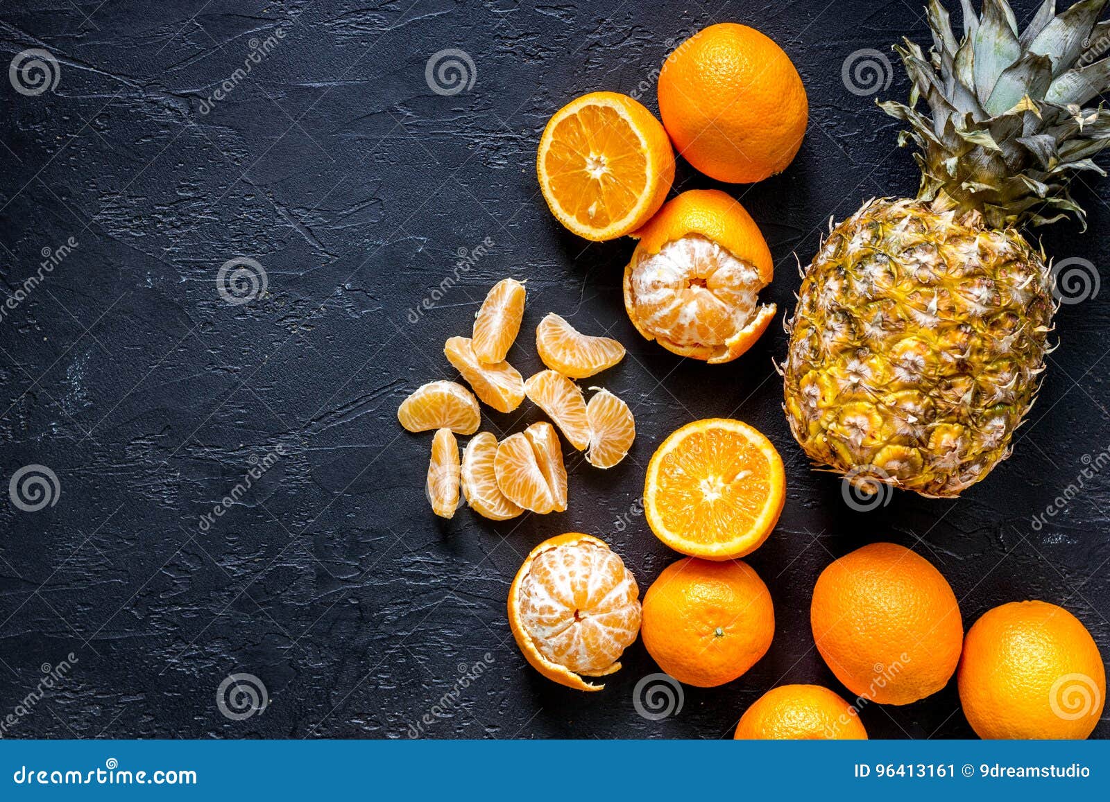 Fresh Oranges, Mandarins and Pineapple on Black Table Background Top