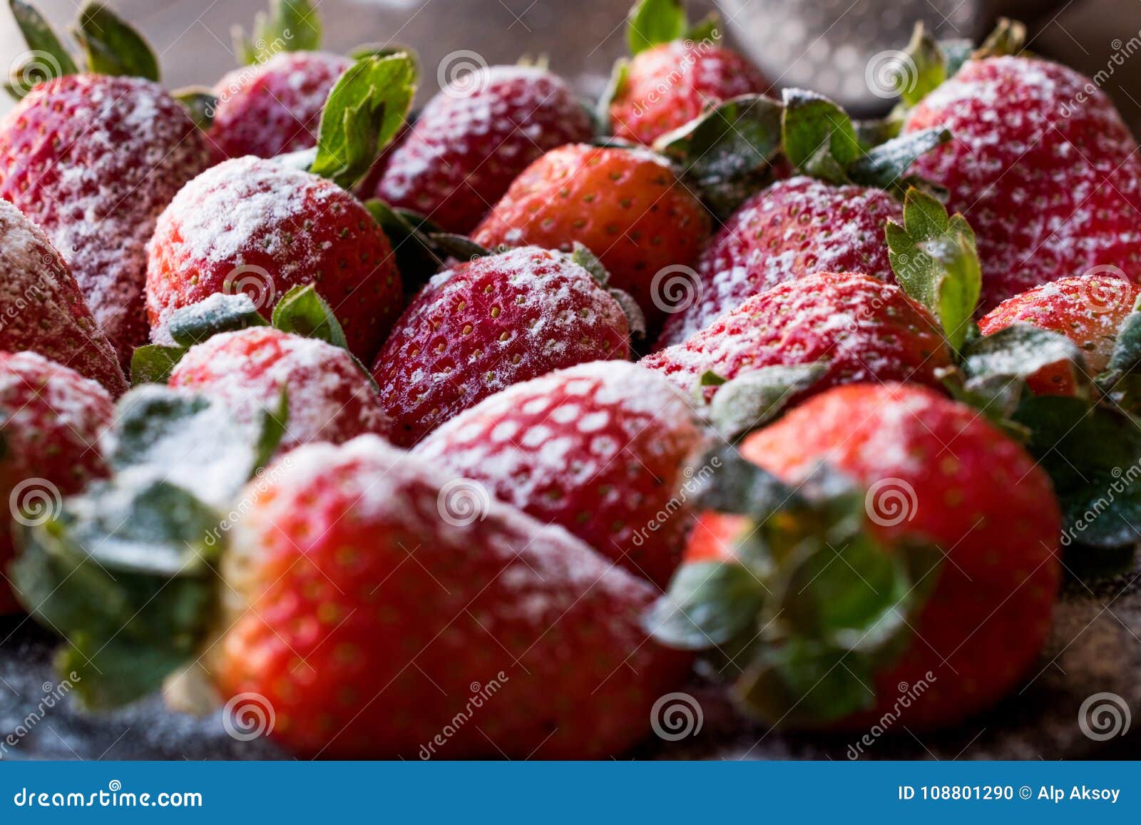 Fresh Organic Ripe Strawberries with Powdered Sugar on Black Plate