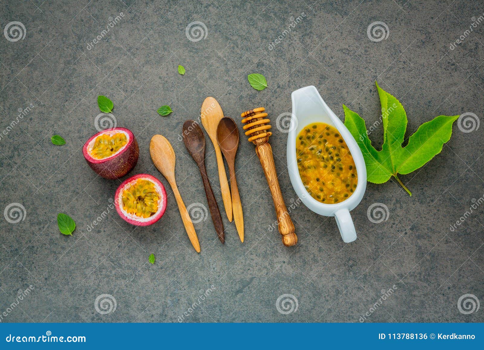Fresh passion fruits set up on dark stone background. Passion fruits and juice with pepper mint leaves. Healthy food backgroud concept.