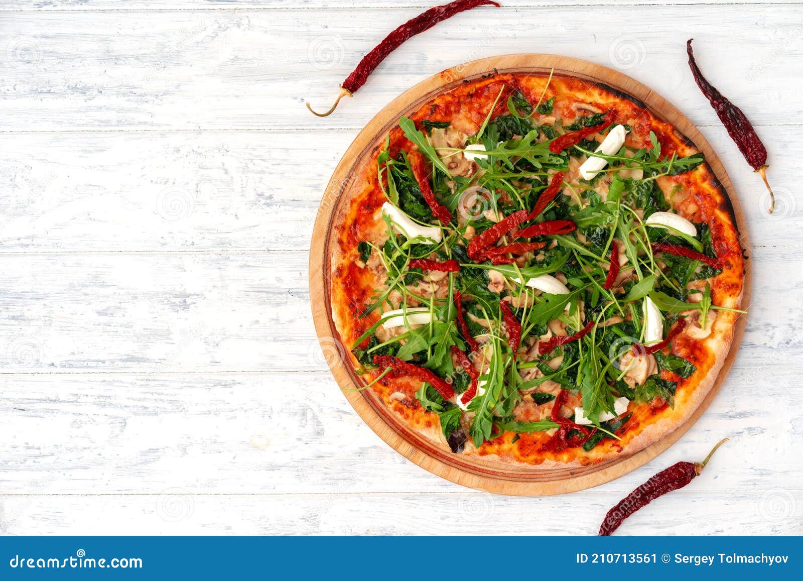 Fresh Pizza with Herbs and Sun Dried Tomatoes on Gray Table Stock Image