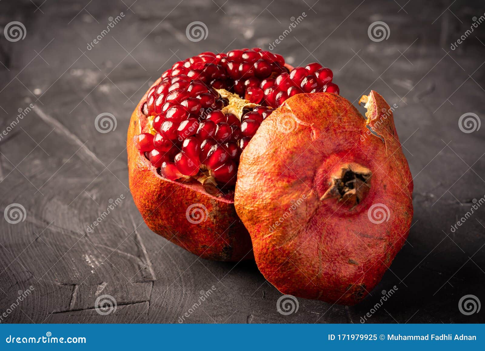 fresh pomegranate on dark surface