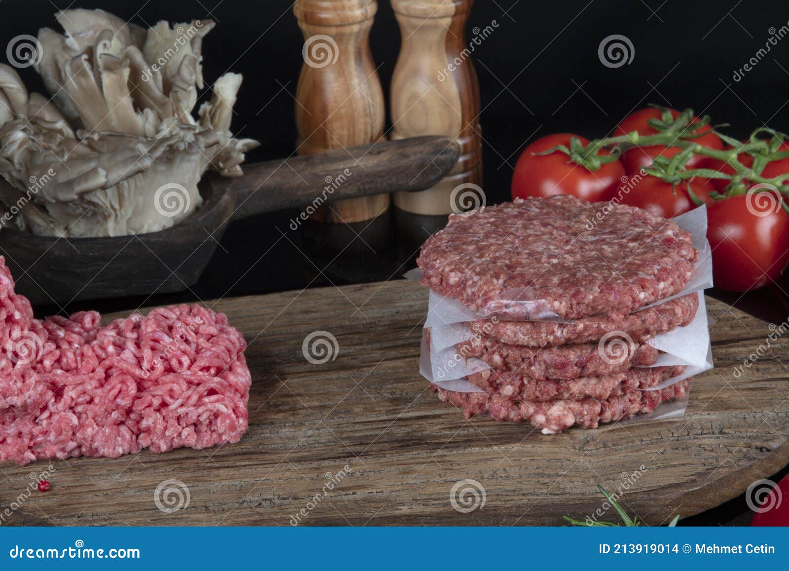 Fresh Raw Homemade Minced Beef Steak Burger with Spices on Black