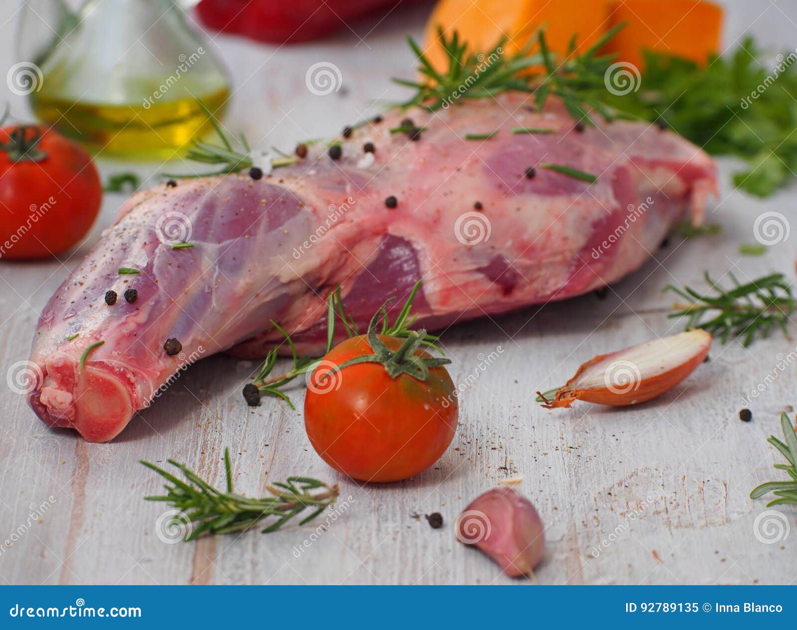 fresh and raw meat. leg of lamb on wood background