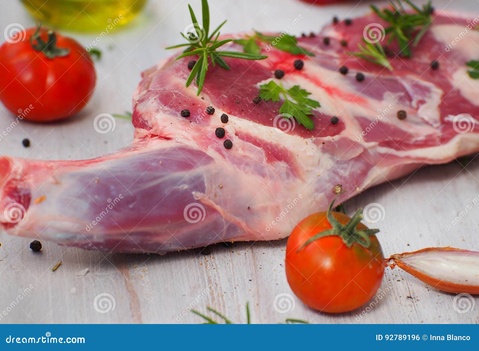 fresh and raw meat. leg of lamb on wood background