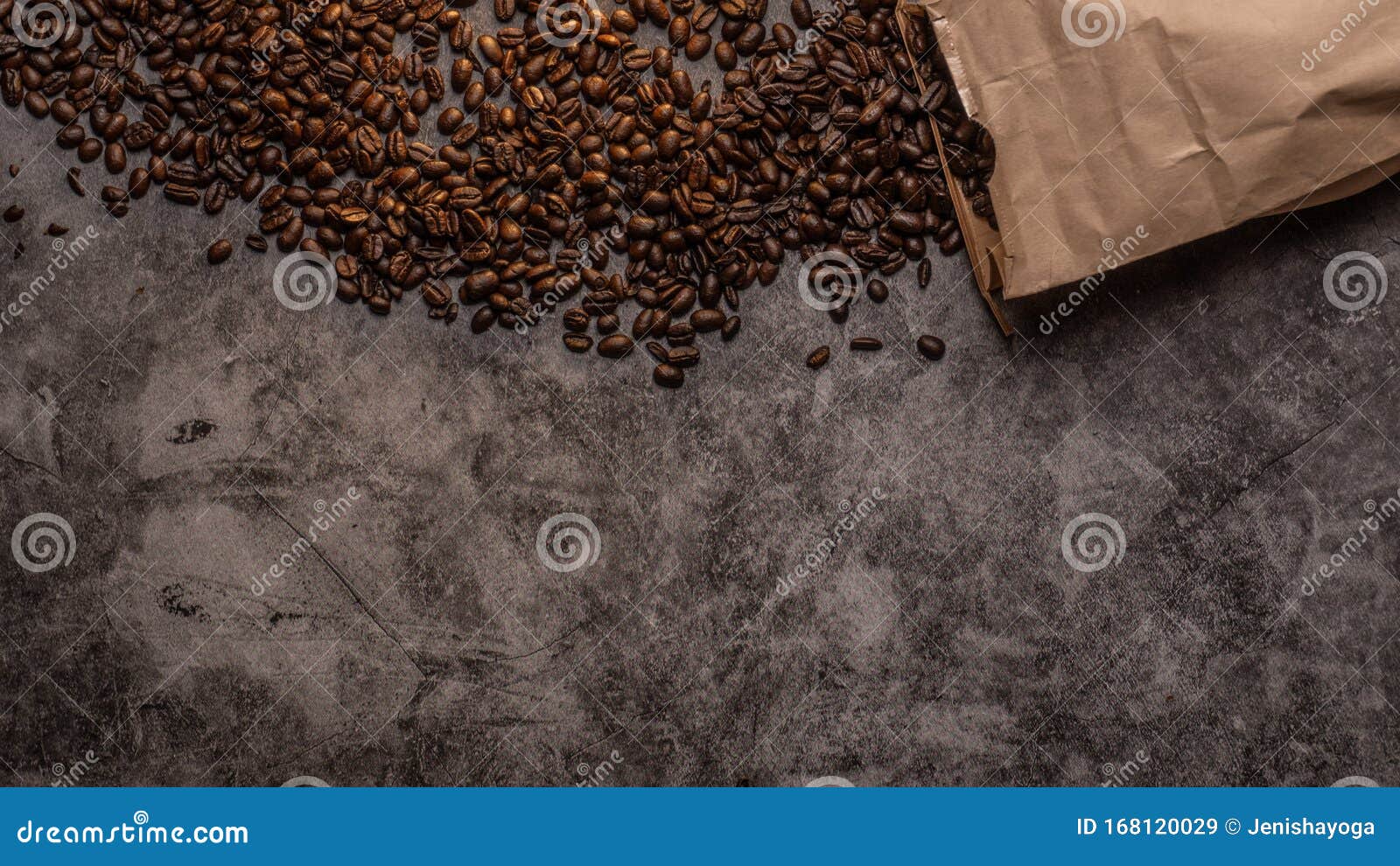 Fresh Raw Organic Coffee Beans Spilled Out Of A Paper Bag On A