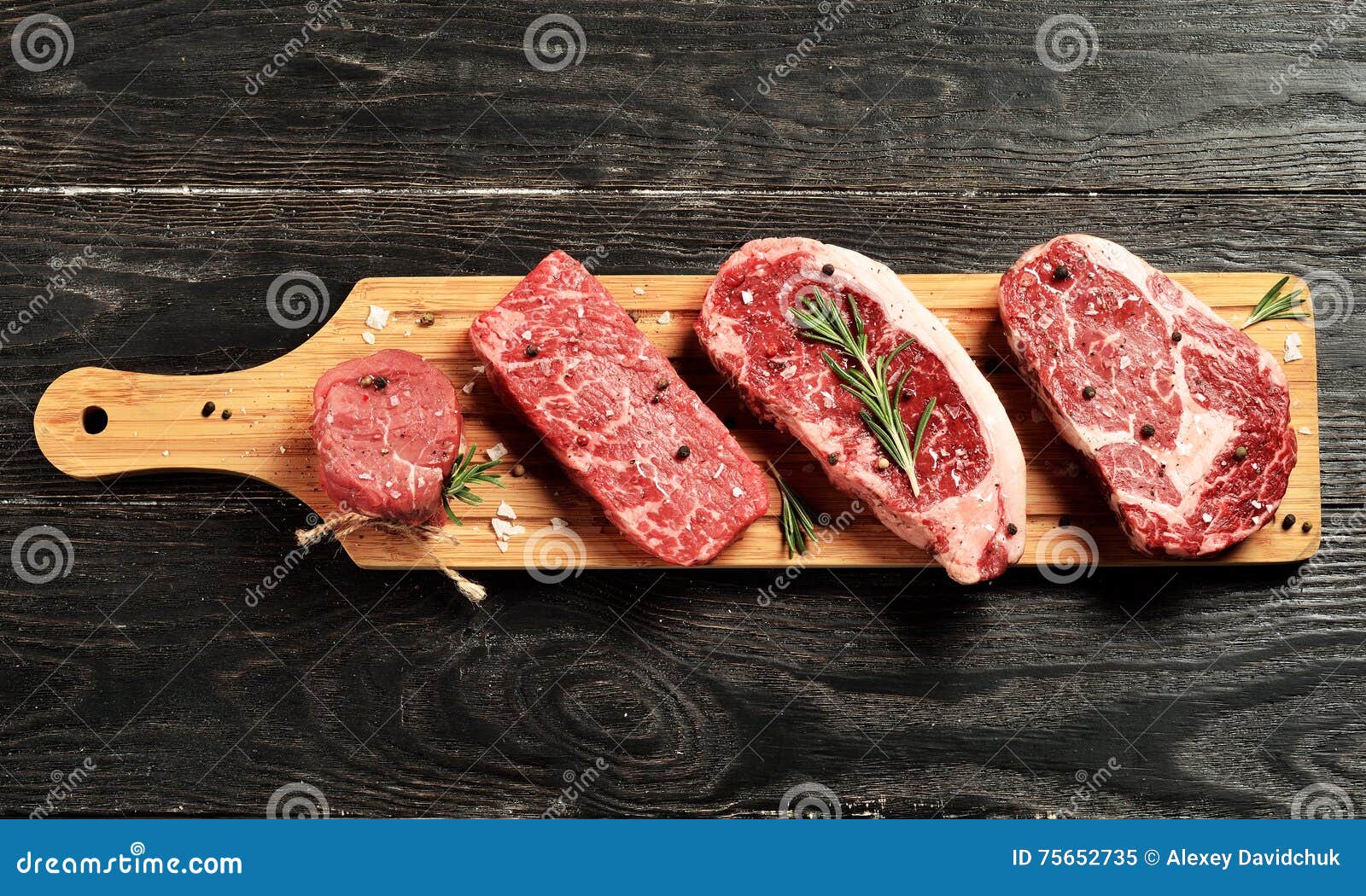 fresh raw prime black angus beef steaks on wooden board