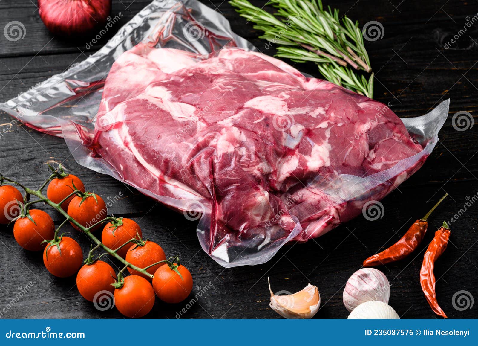 Fresh, Raw, Vacuum Packed Cut Lamb Meat, with Ingredients and Herbs, on