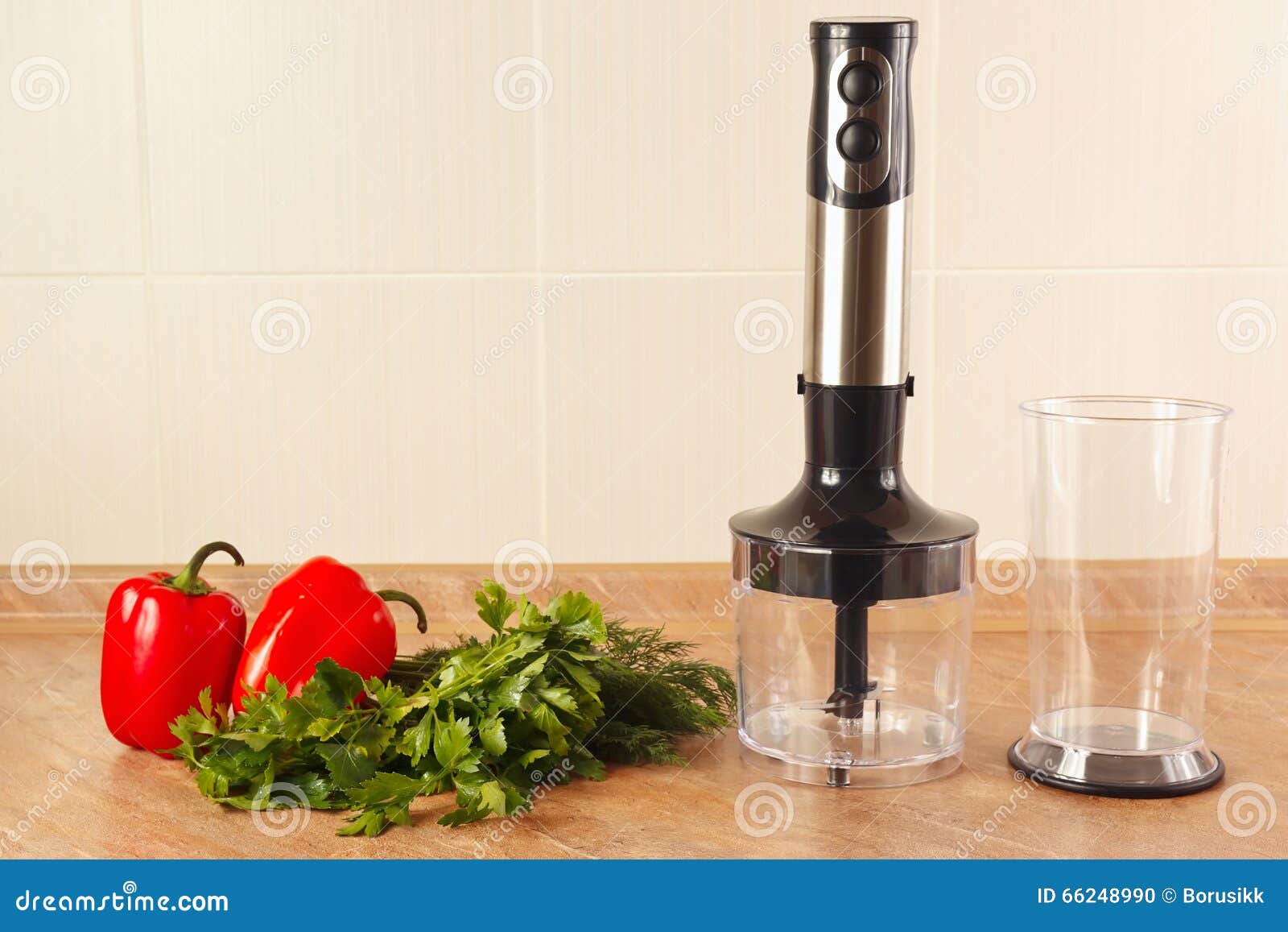 fresh red bellpepper with herbs and a blender on kitchen table