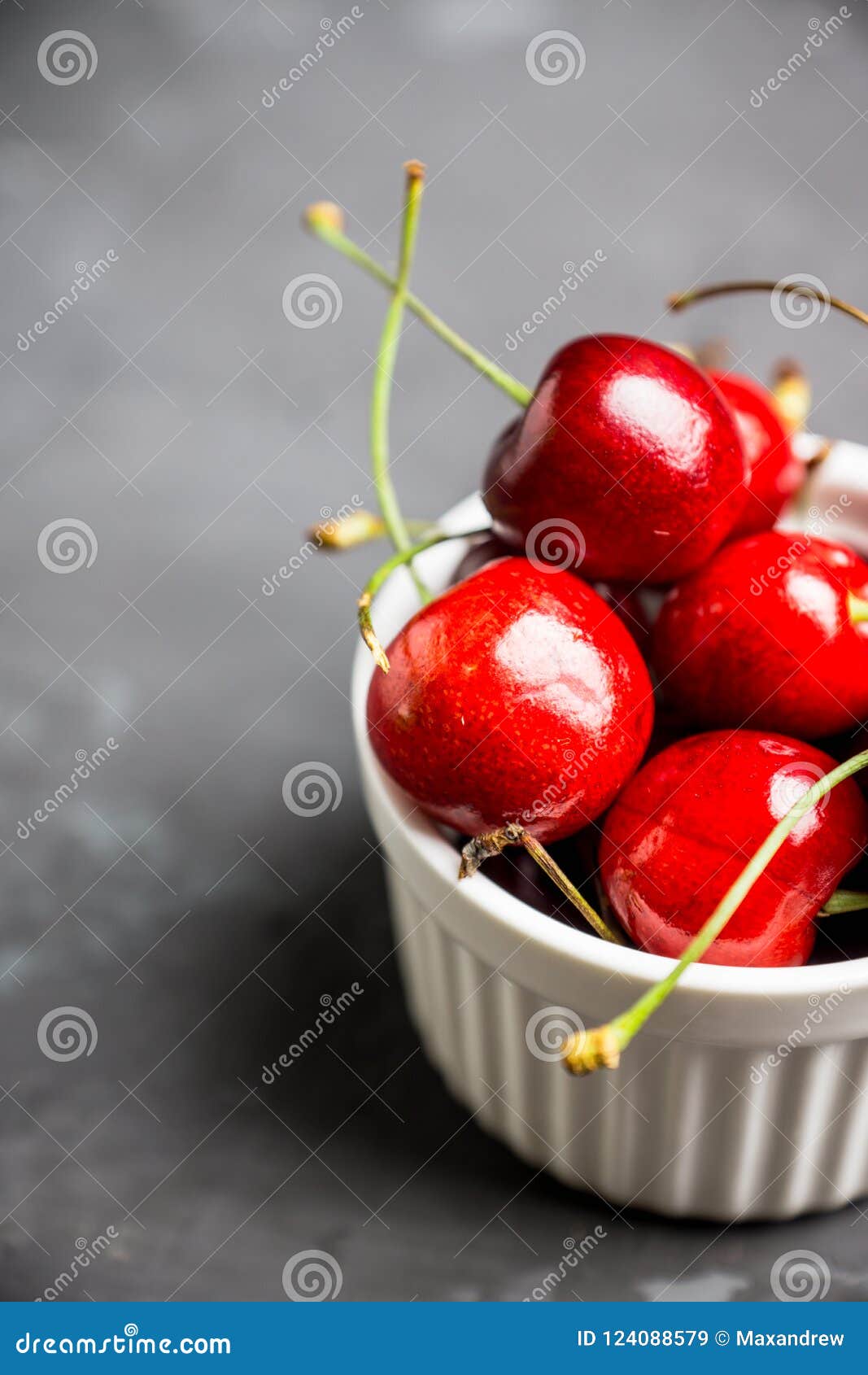 Fresh Ripe Cherries in Small White Ceramic Bowl on the Rustic