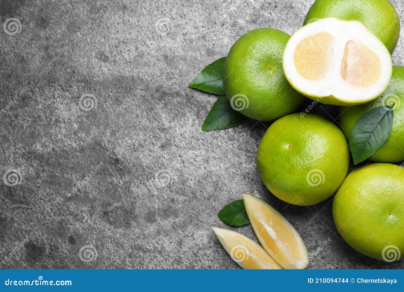 fresh ripe sweeties on grey table, flat lay. space for text