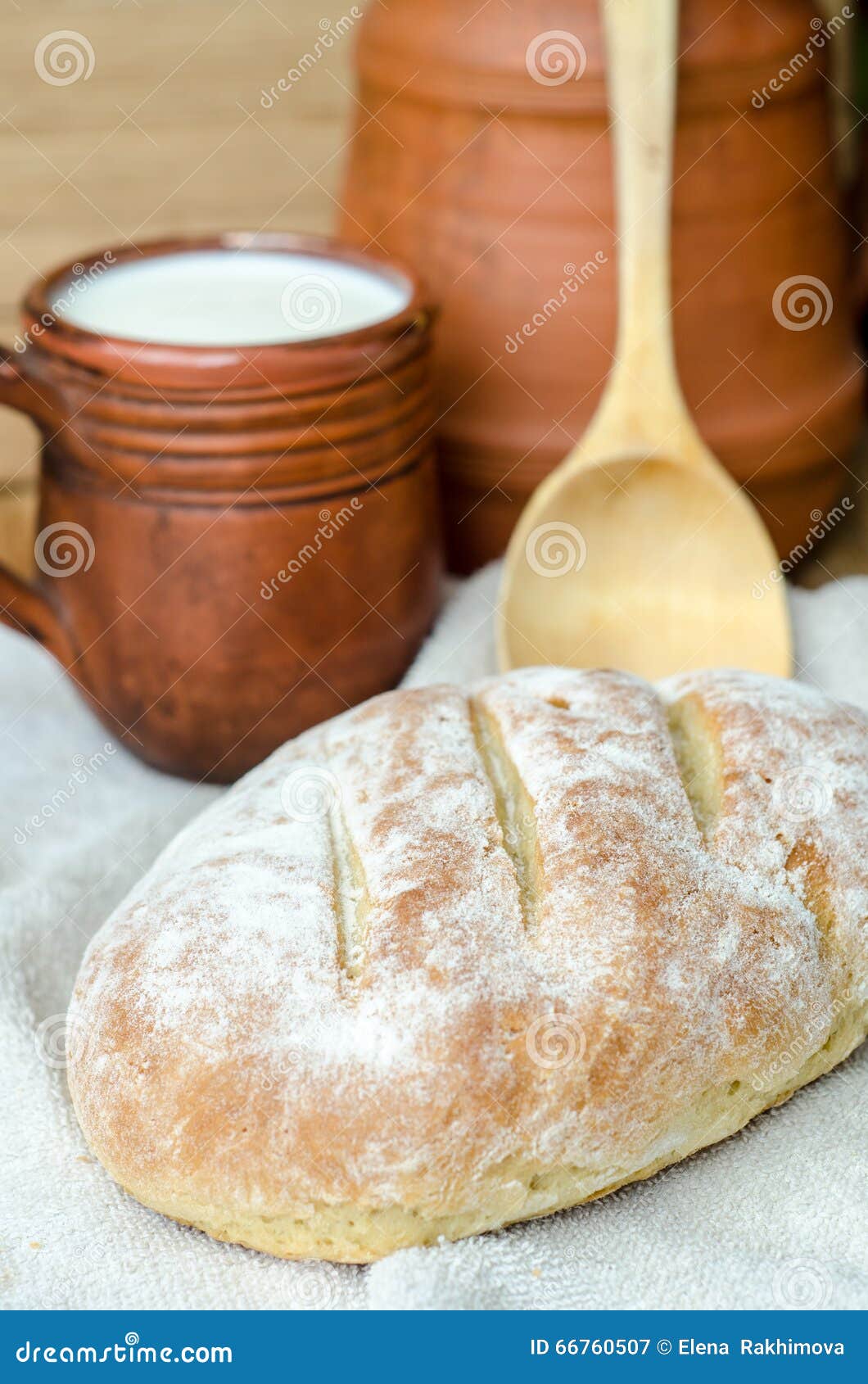 Fresh Rustic Bread with Cup of Milk and Wooden Spoon Stock Image