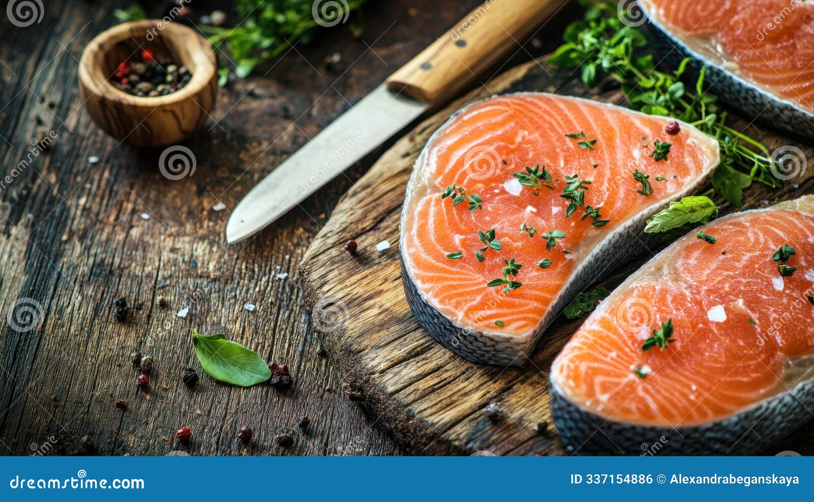 fresh salmon steaks on wooden table with herbs and spices