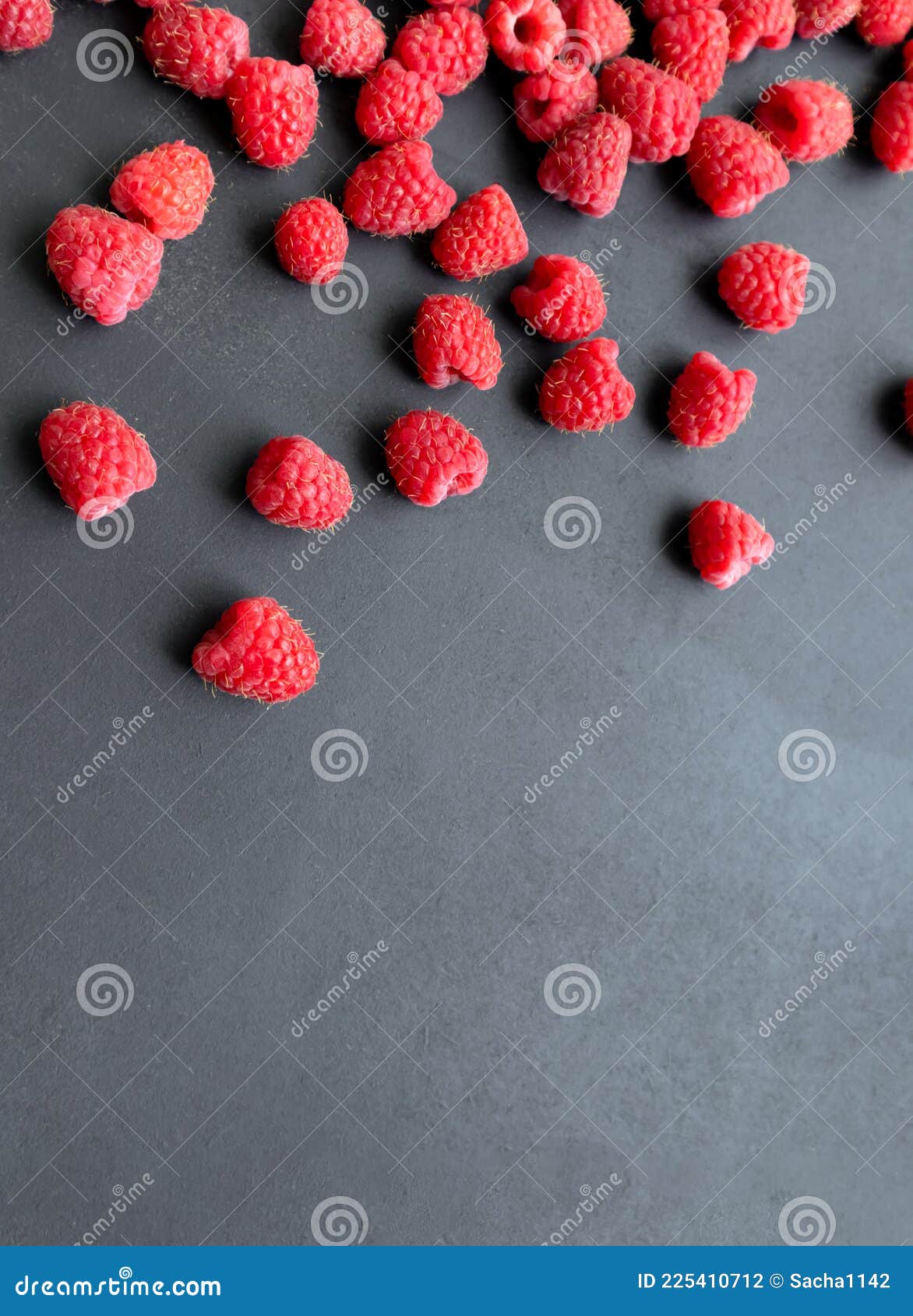 fresh and sweet raspberry in a dark background. top view