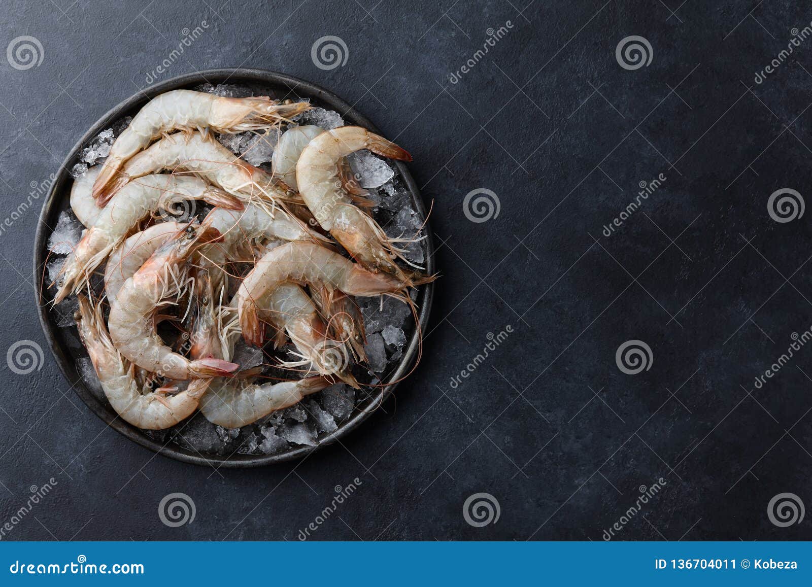 fresh tiger prawns in a plate with ice