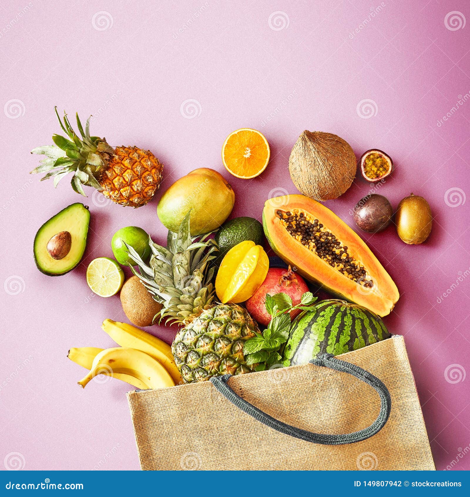 fresh tropical fruit on a colorful pink background