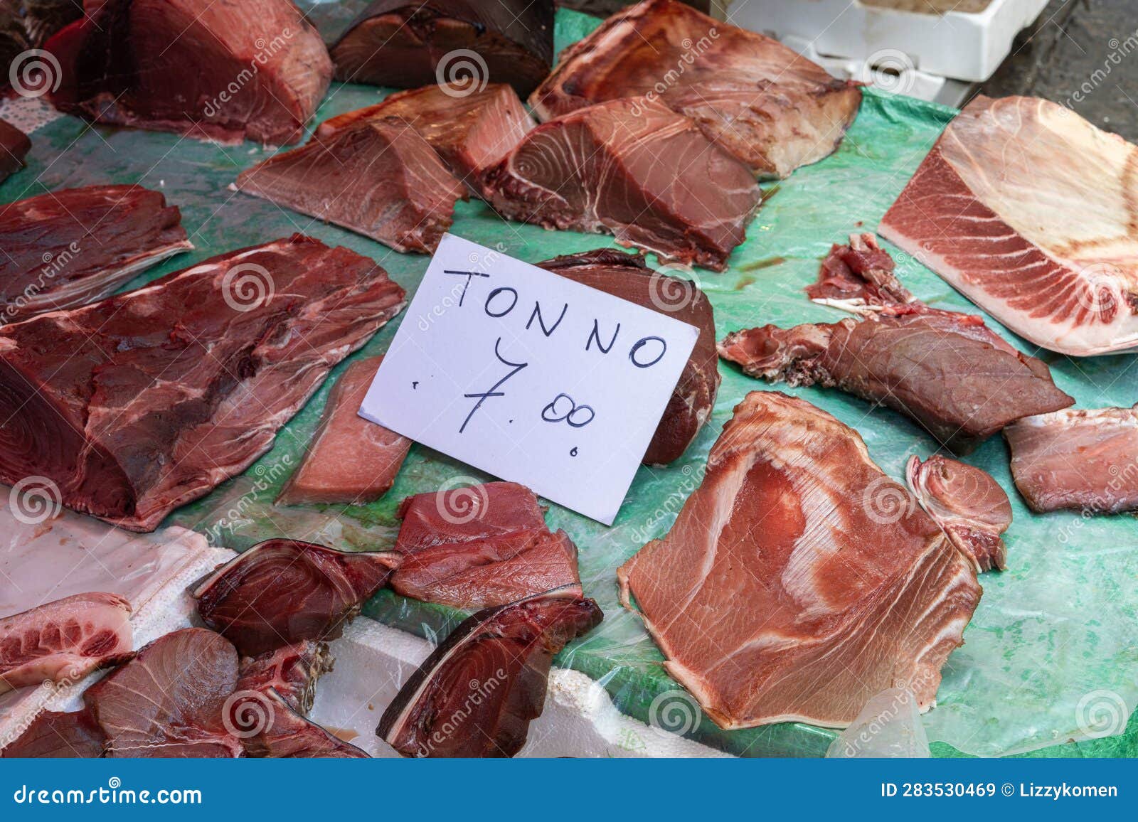 fresh tuna sold at a market in italy with sign tonno (translation: tuna) and price