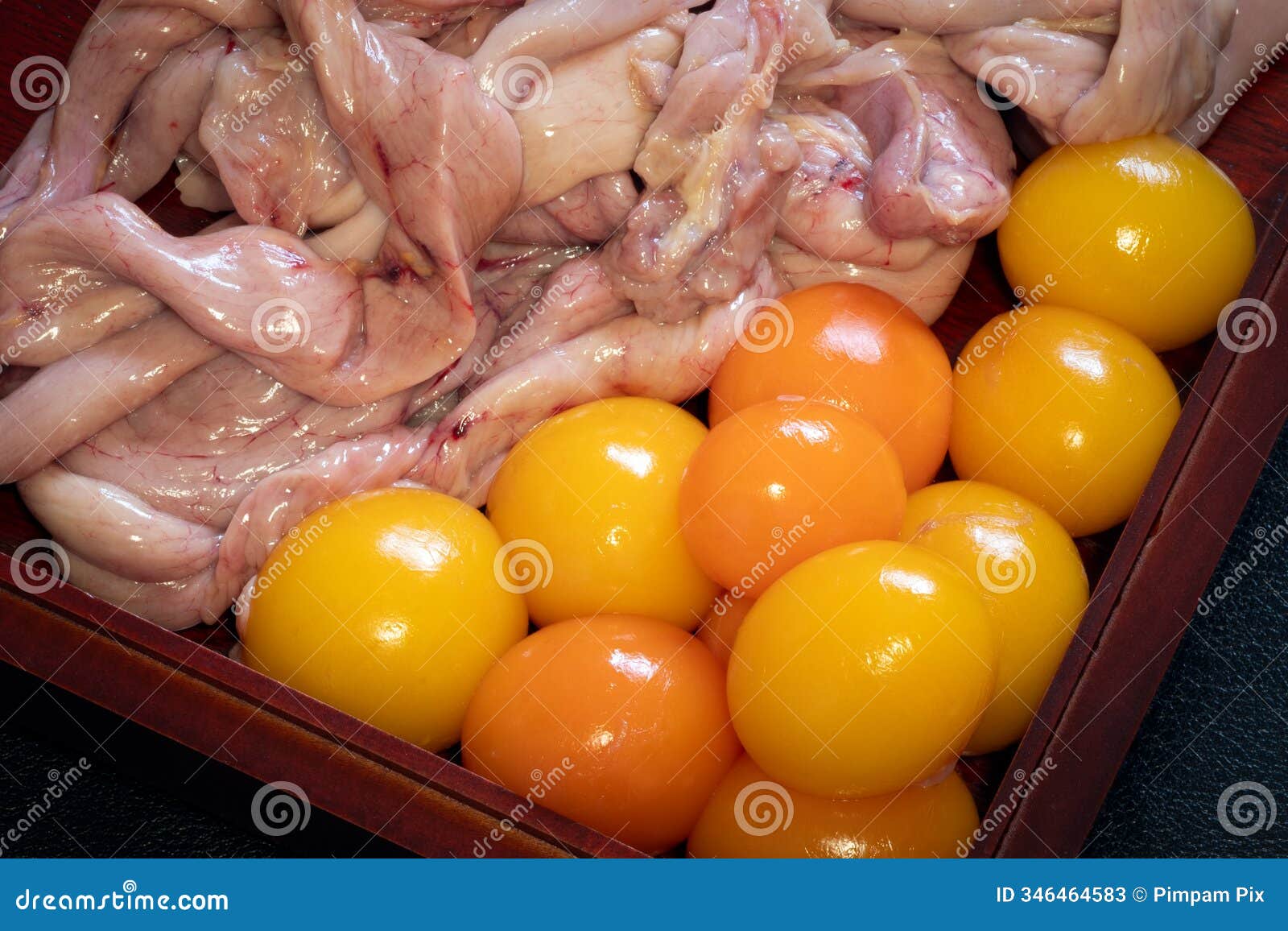 fresh unlaid chicken eggs with chicken intestines and organs