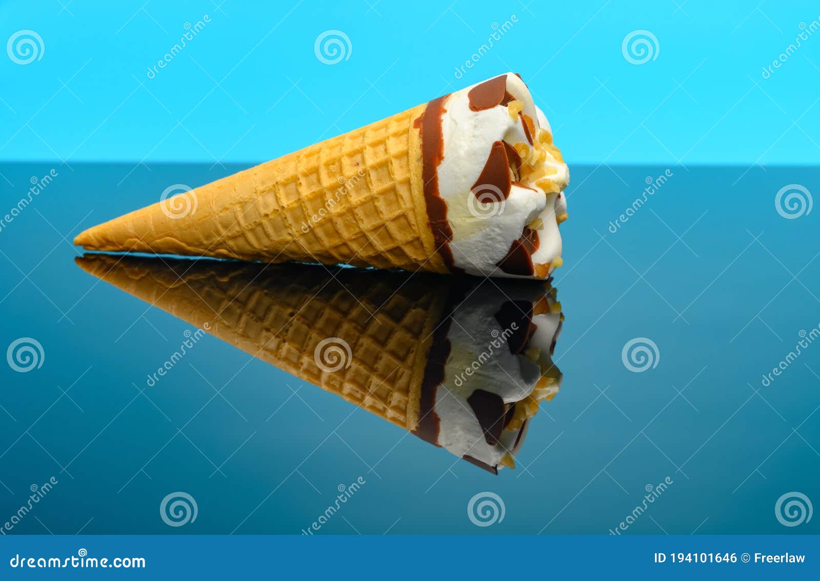 A Fresh Vanilla Flavor Ice Cream Cone on a Glass with Reflection Stock