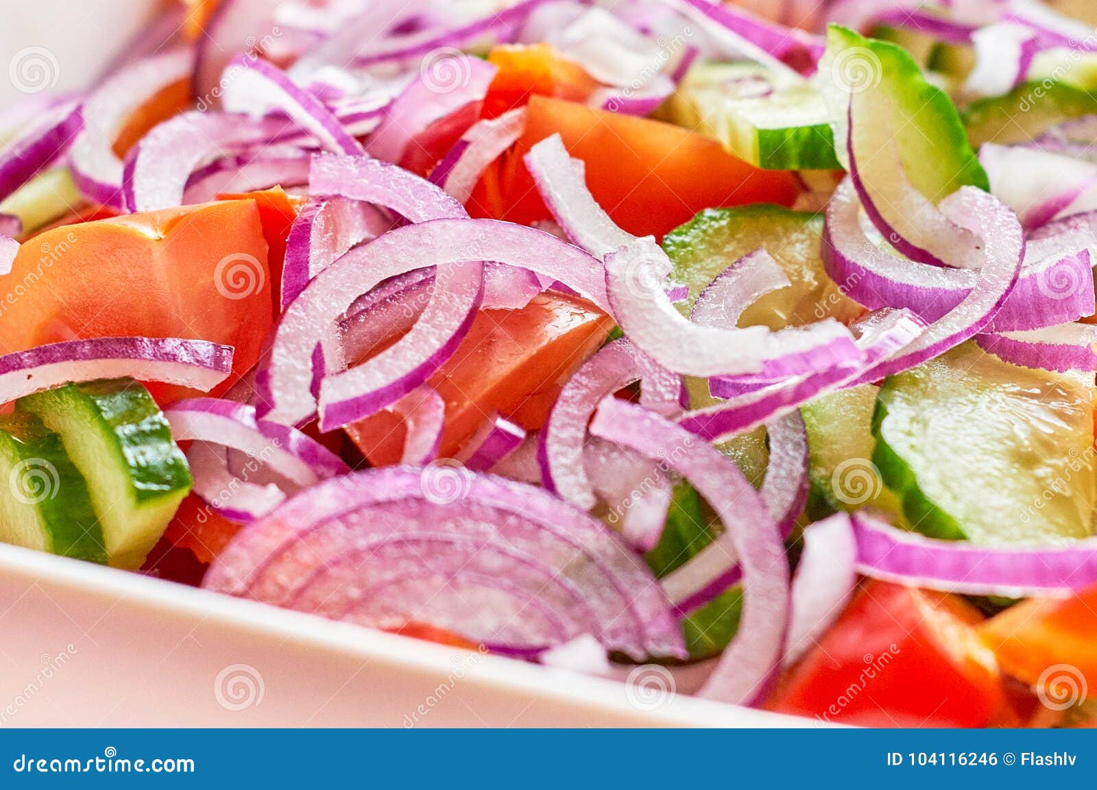 fresh vegetable salad with onion and tomatoes macro view