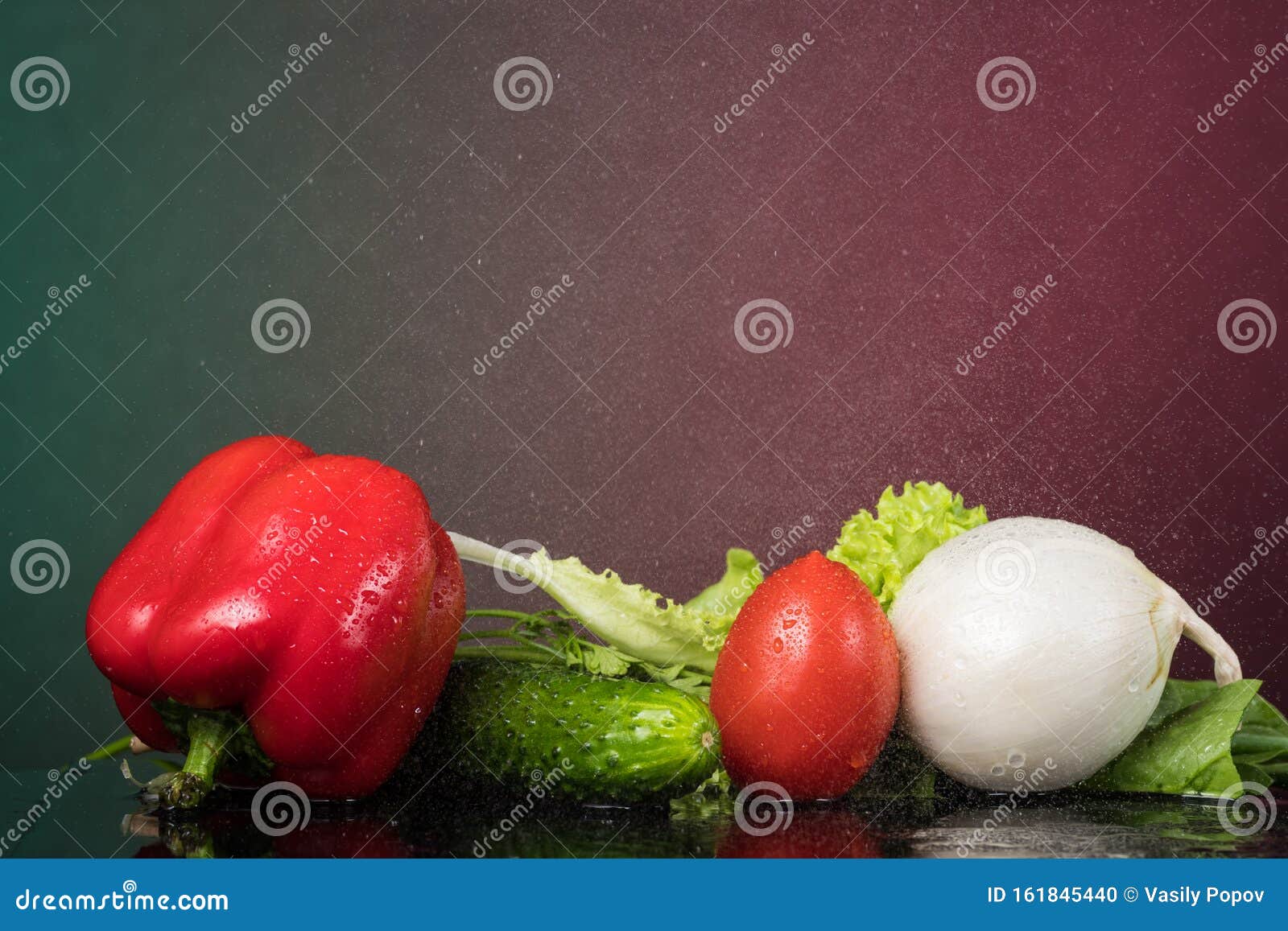 fresh vegetables with drops of water on a black background, pidor, cucumber, bell pepper, onion, greens
