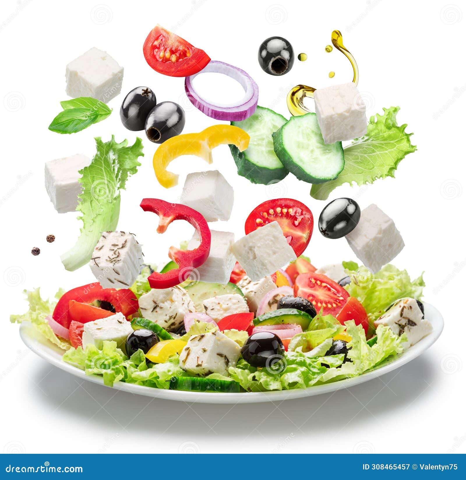fresh vegetables and feta cheese falling down into the white plate . file contains clipping paths