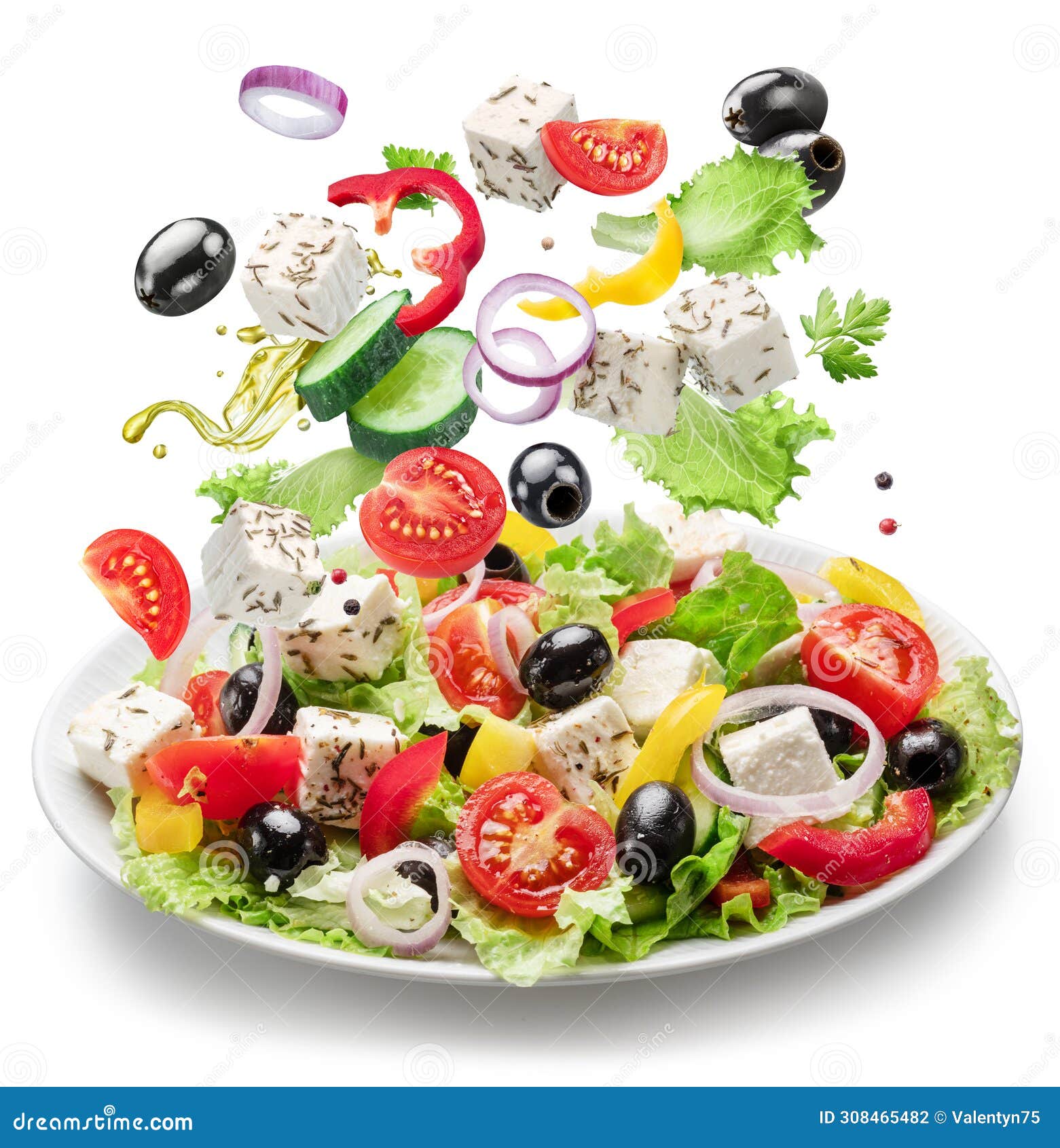 fresh vegetables and feta cheese falling down into the white plate . file contains clipping paths