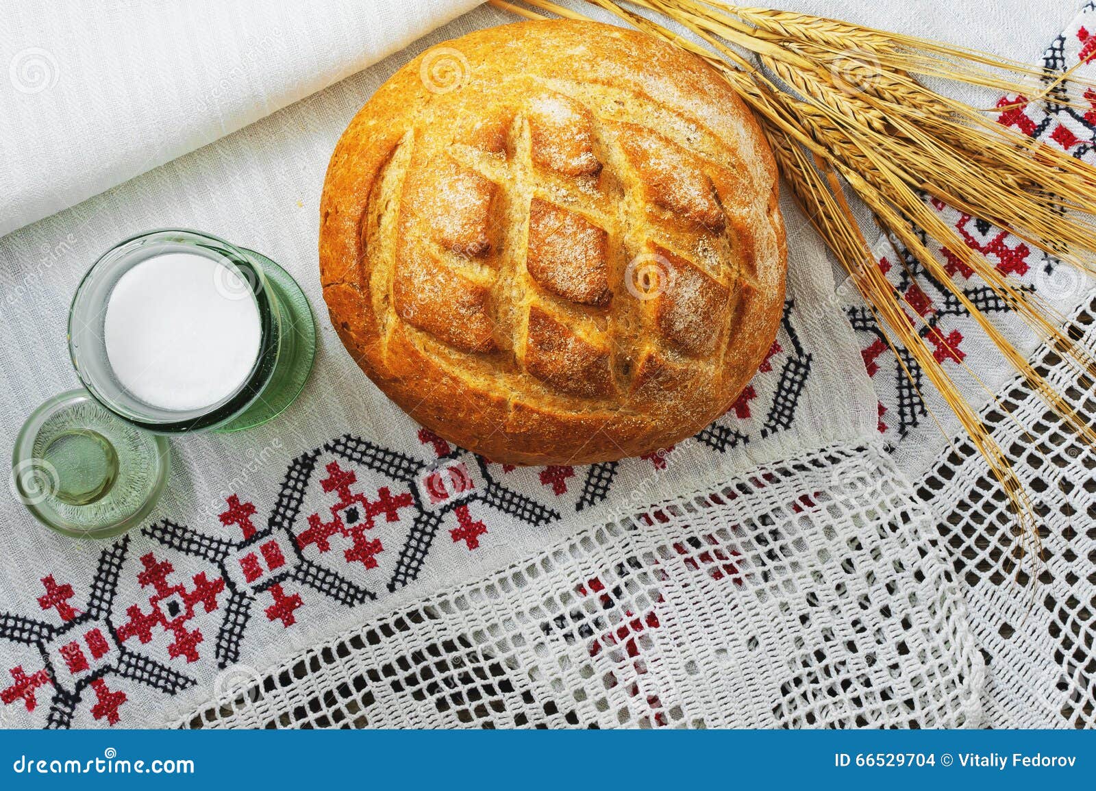 Fresh White Bread, Salt in a Glass Jar and Rye on Background