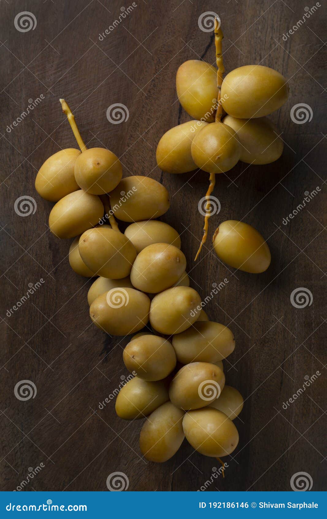 Fresh Yellow Dates Fruit Isolate on Wooden Background Stock Photo