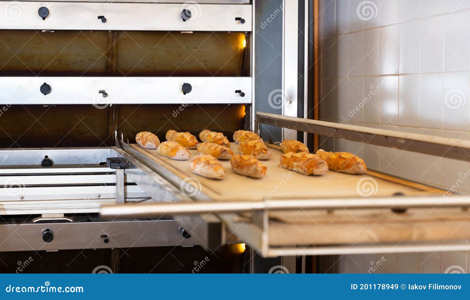 Freshly Baked Baguettes Near Oven in Bakery Stock Image