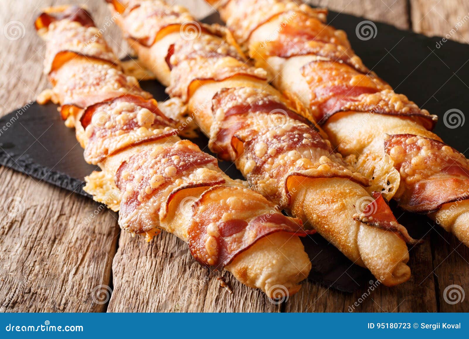 Freshly Baked Bread Sticks with Bacon and Cheese Closeup. Horiz Stock
