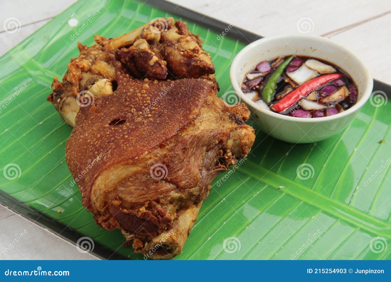 freshly cooked filipino food called crispy pata or deep fried crispy pork leg