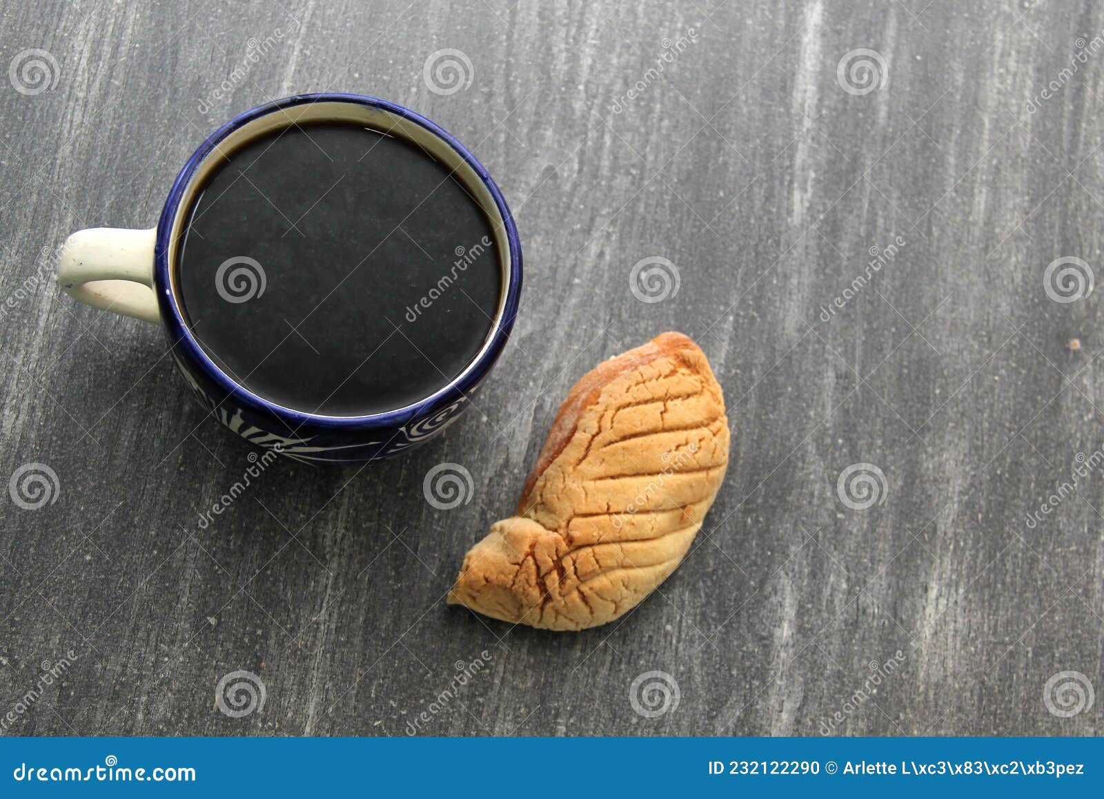 fresh, fluffy, sugary and freshly made sweet bread stuffed with mexican town cheese called gusano on wooden table on colored napki