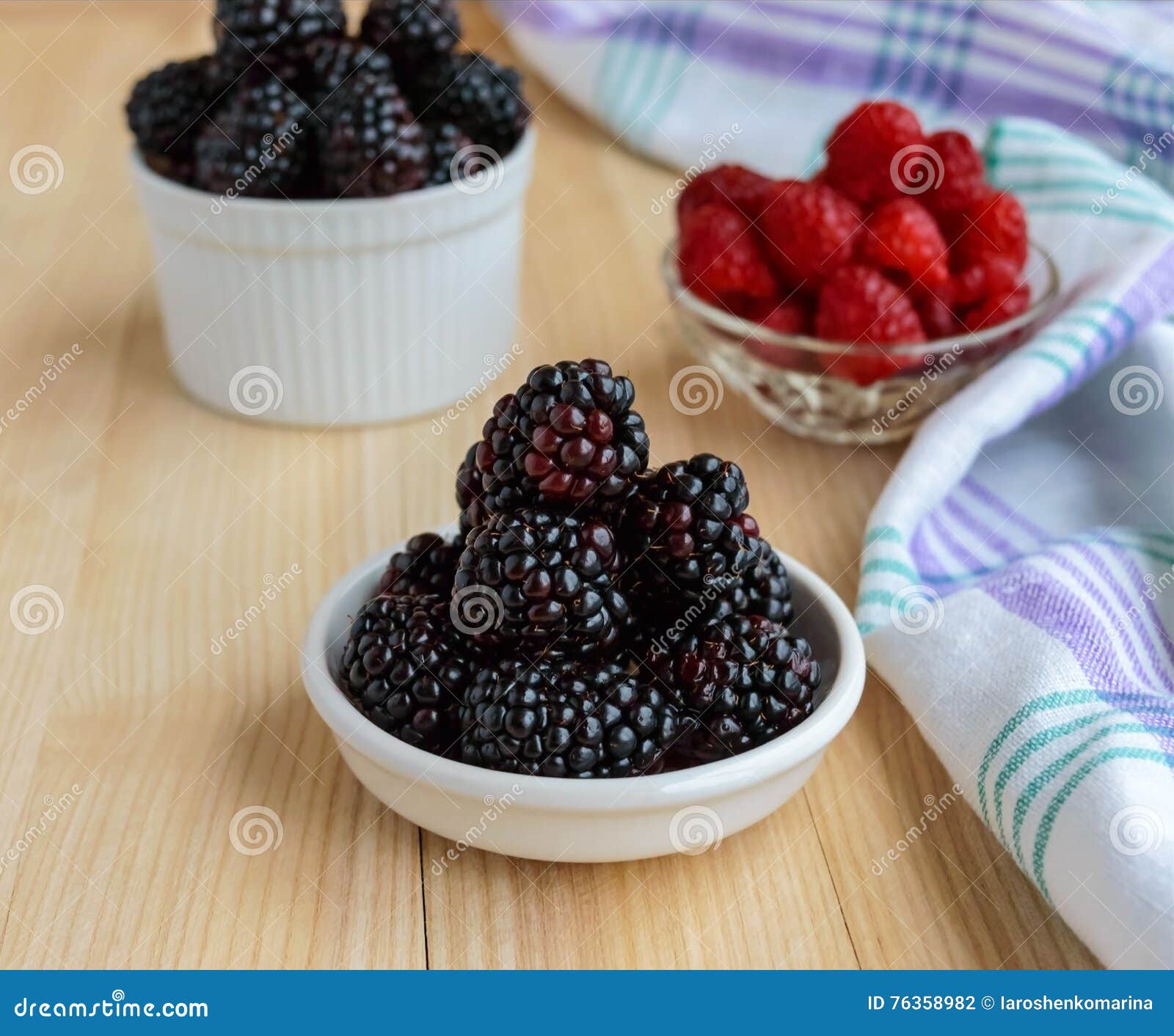 Freshly Picked Blackberries and Raspberries on a Light Wooden ...