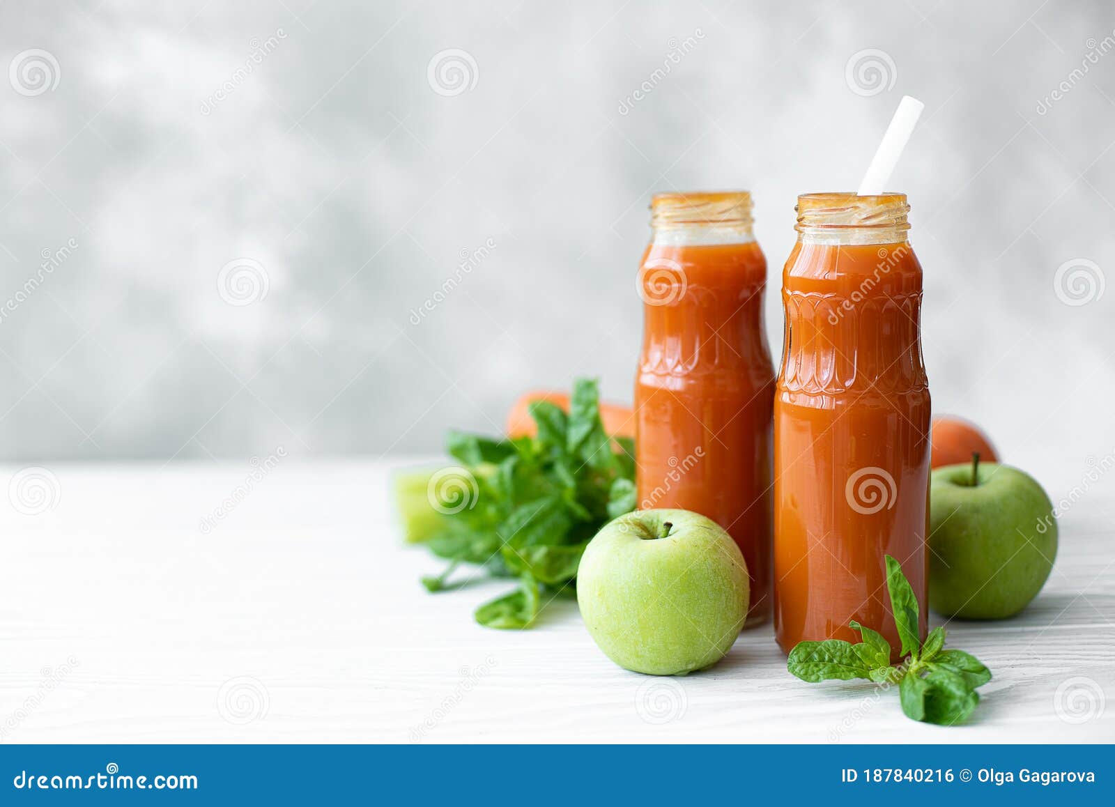 Freshly Squeezed Carrot Juice in Bottles with Vegetables Stock Photo
