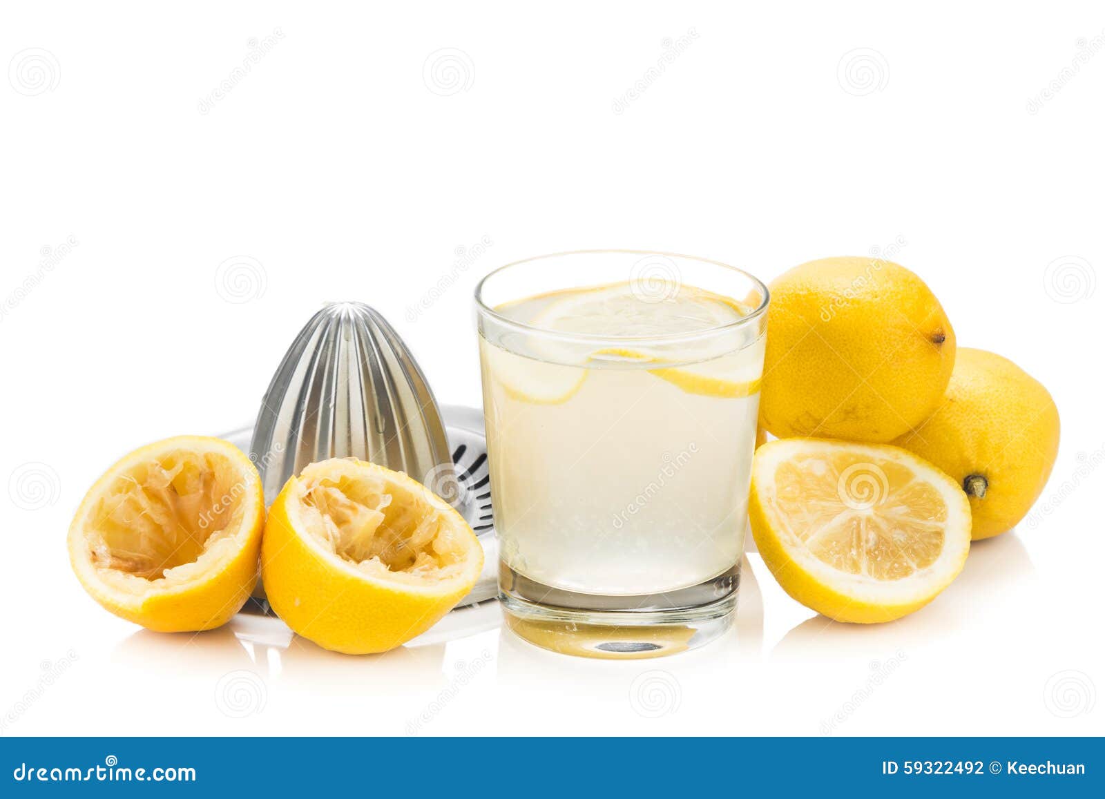 Freshly Squeezed Organic Lemon Juice with Glass and Squeezer. Stock