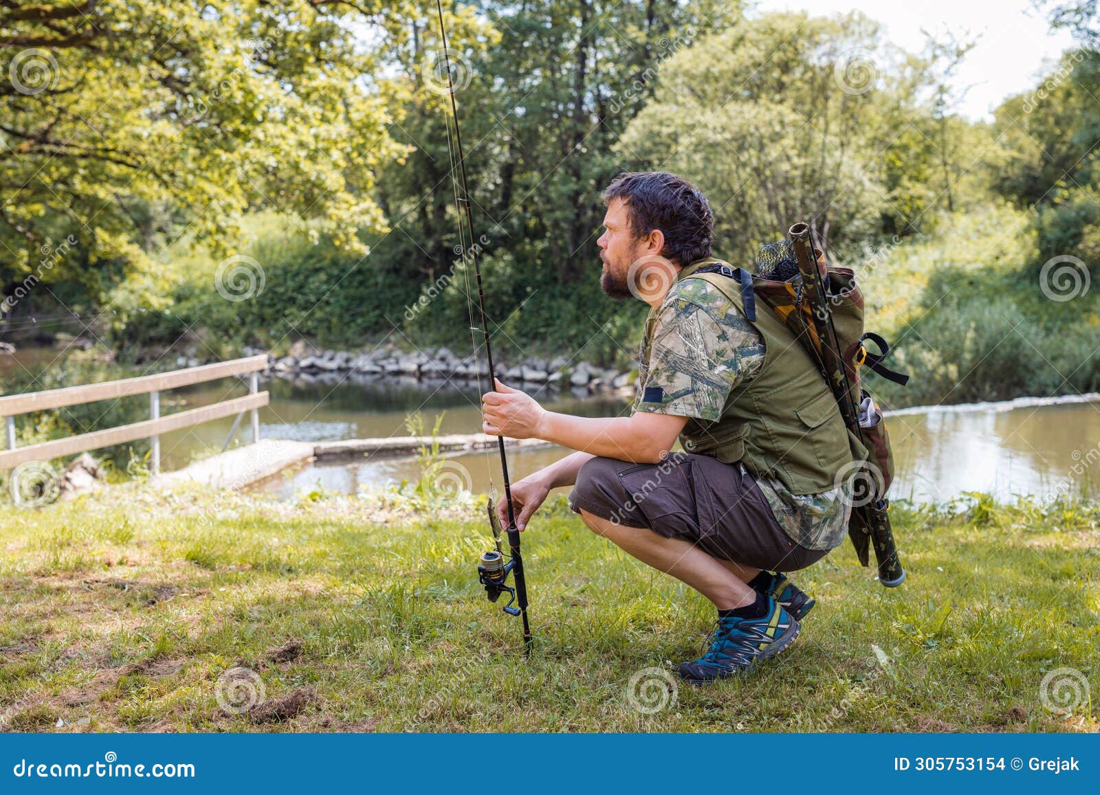 Freshwater Fisherman Holding a Fishing Rod with a Spinning Reel